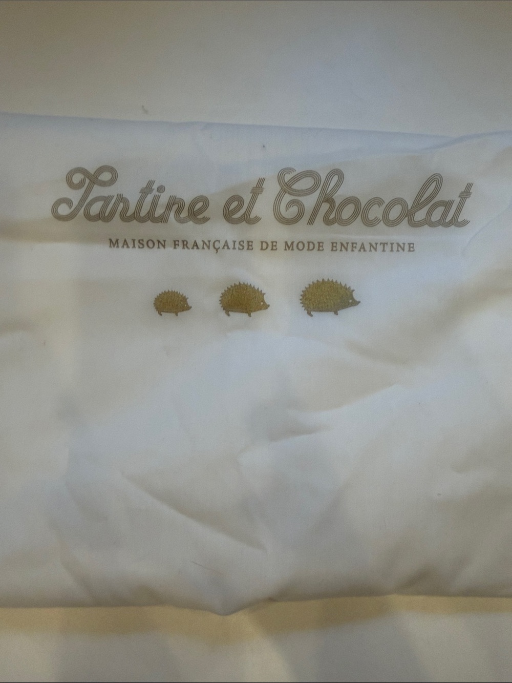 Tartine et Chocolat White Garment Bag with Gold Hedgehog Accents